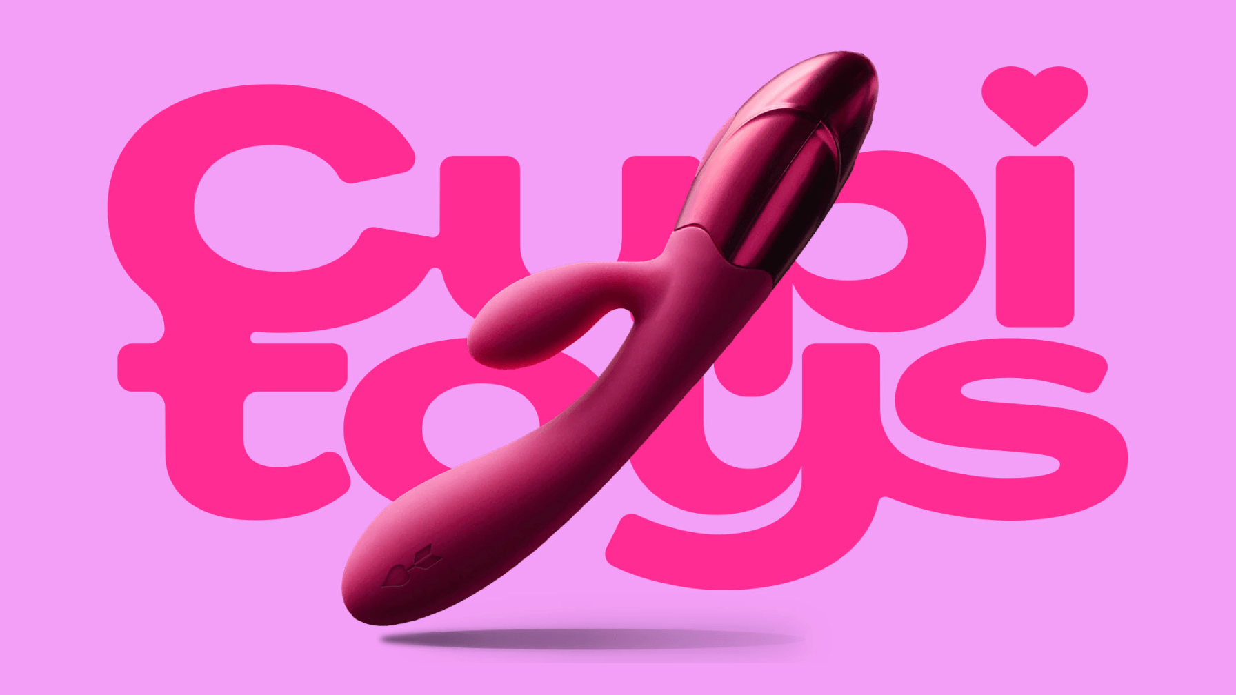 A close-up image of a vibrant pink vibrator is centered on a light pink background. Behind it is the bold, magenta, cursive-style logotype "Cupid Toys," with a small heart graphic.