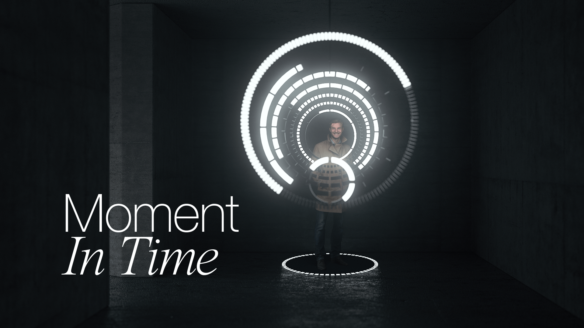 A man standing in a dark, concrete room, surrounded by bright, glowing white concentric digital rings that form a circular user interface, with the text "Moment In Time" overlaid in white cursive font in the lower left.