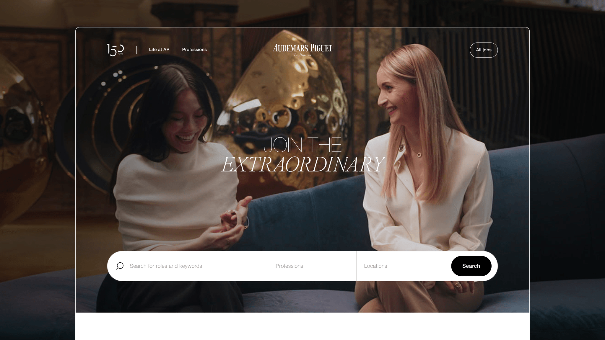 Audemars Piguet employer brand homepage featuring a prominent search bar for filtering job roles, professions, and locations. A lifestyle photo of two women relaxing on a couch is visible in the background.