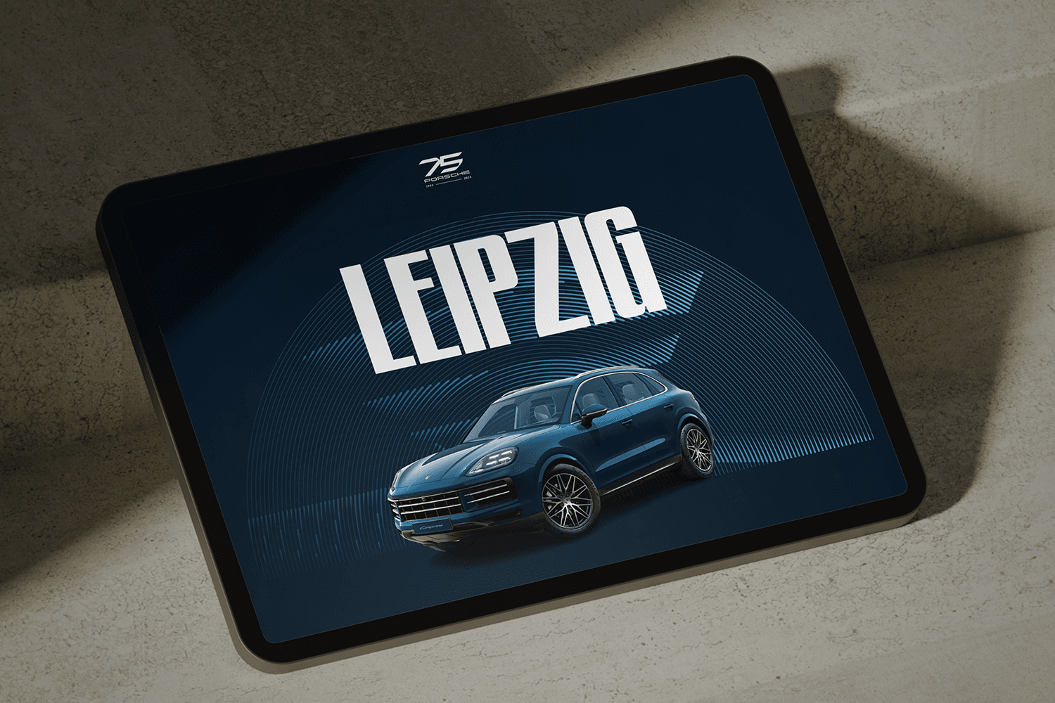 Tablet displaying a blue SUV with large 'LEIPZIG' text on a dark blue graphic background