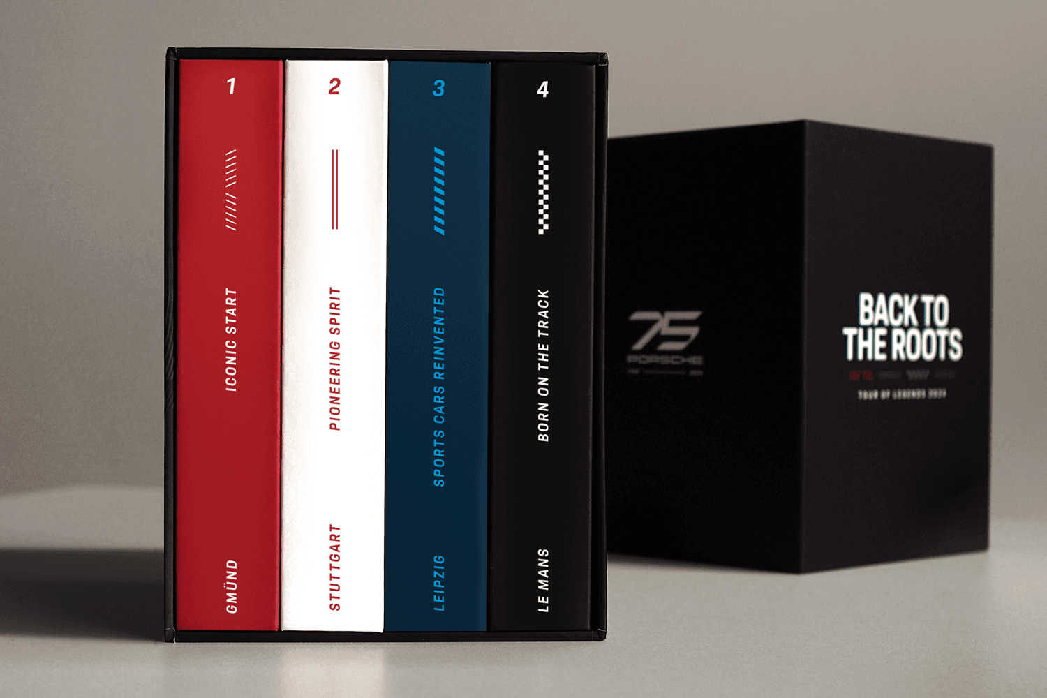 Box set of four numbered book spines (red, white, blue, black) in a sleeve; black outer box beside reads "BACK TO THE ROOTS" with a "75" logo.