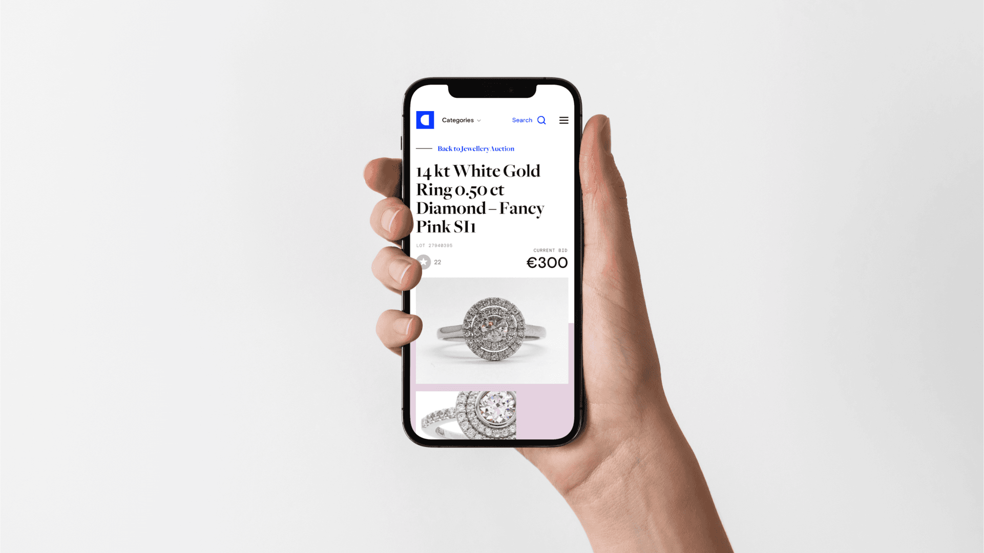 Hand holding smartphone showing an online listing for a 14 kt white-gold diamond ring with a pink center, priced €300.