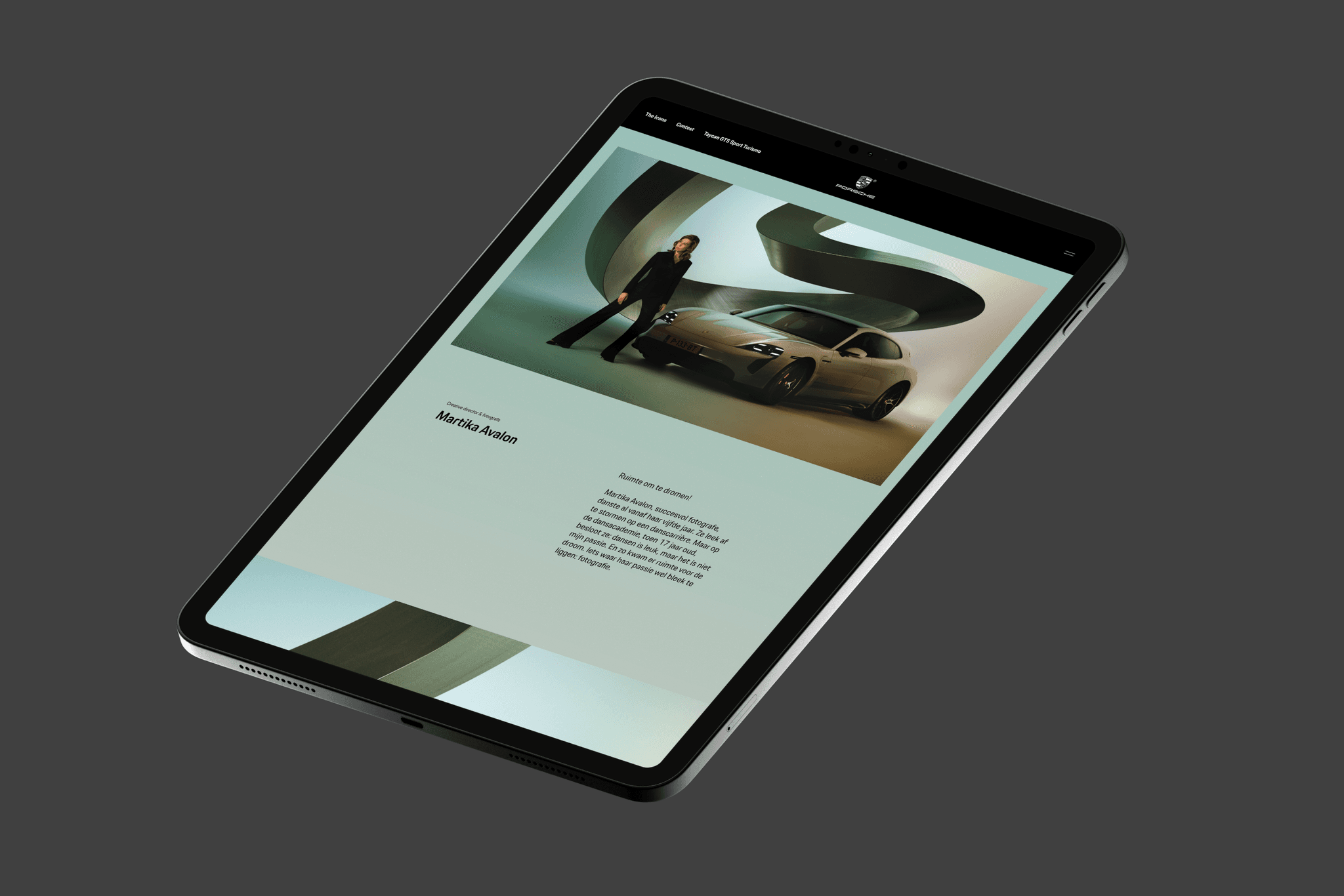 Tablet on dark gray background displaying a webpage with a Porsche, a person beside it, and sweeping abstract green shapes.