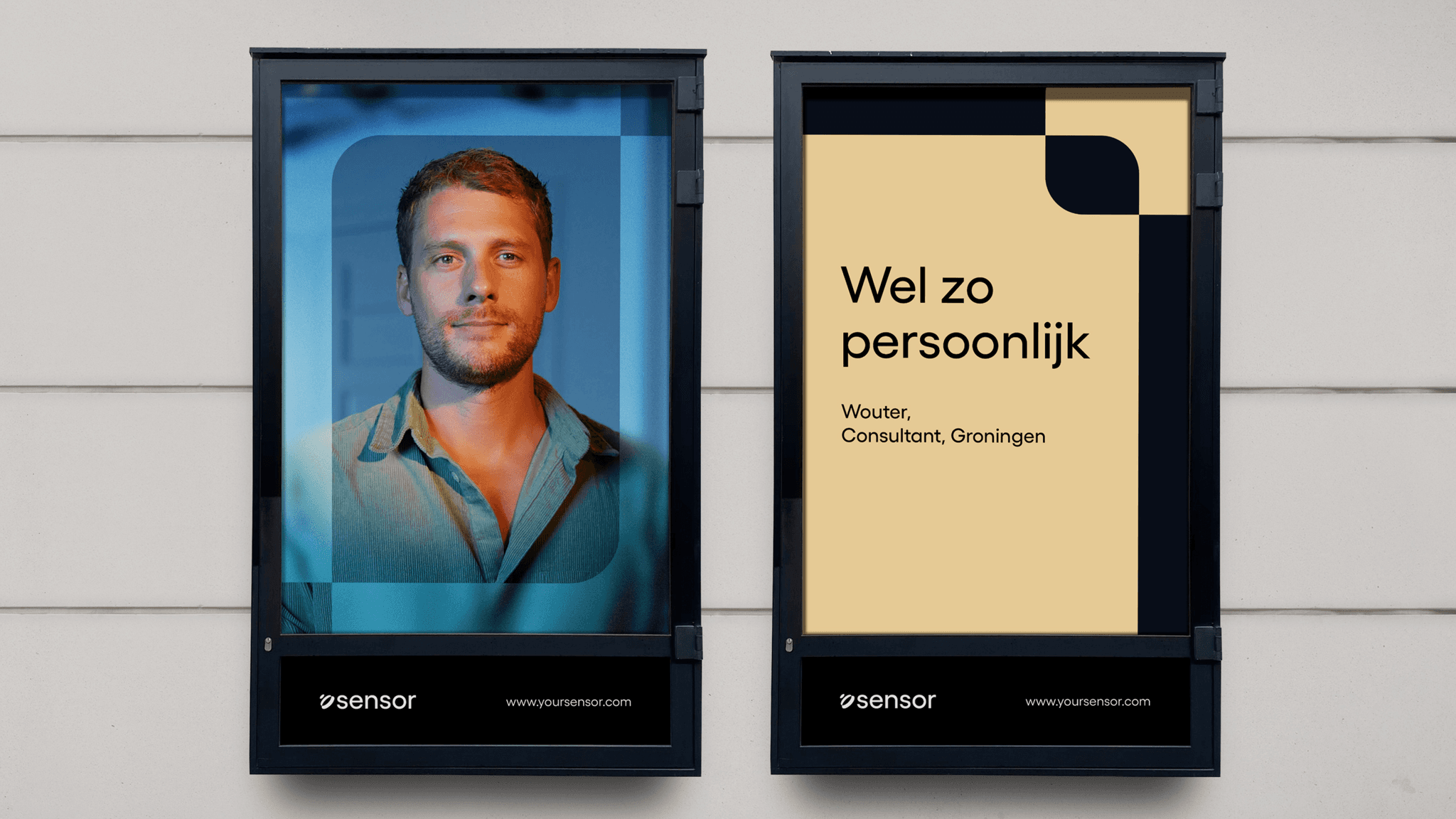 Two framed posters on a wall: left a blue-toned portrait of a man, right a beige graphic reading "Wel zo persoonlijk" with a company logo.