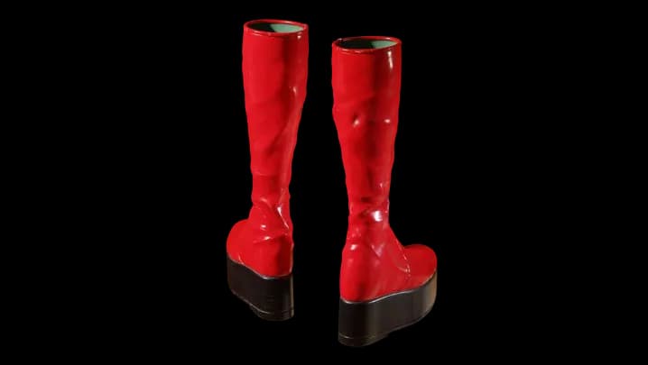 A pair of high-fashion, bright red platform boots with thick black soles, a signature element of Ziggy Stardust's 1970s glam rock aesthetic.