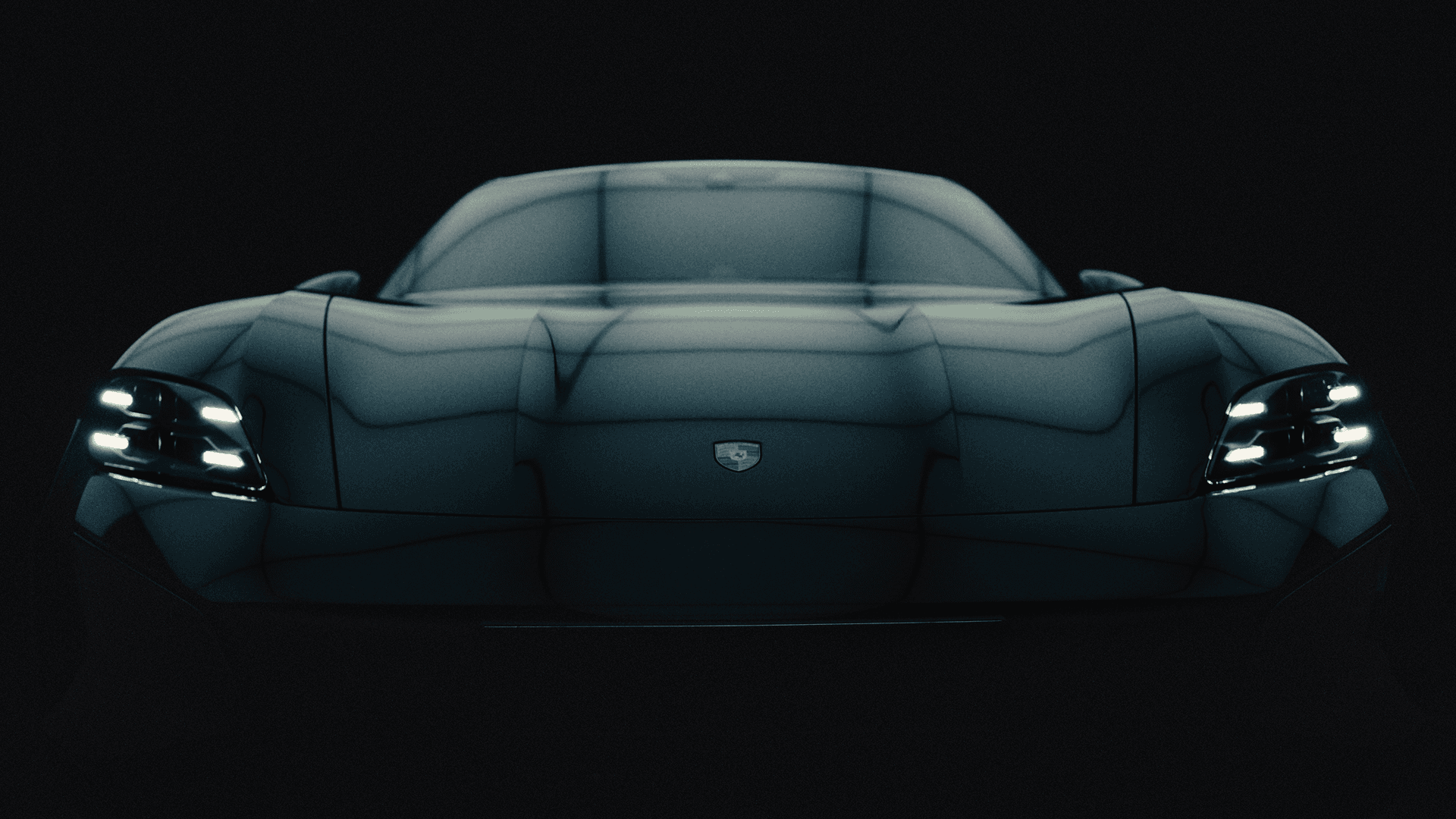 Head-on view of a low-slung dark Porsche with glossy hood, central badge and illuminated headlights in moody lighting.