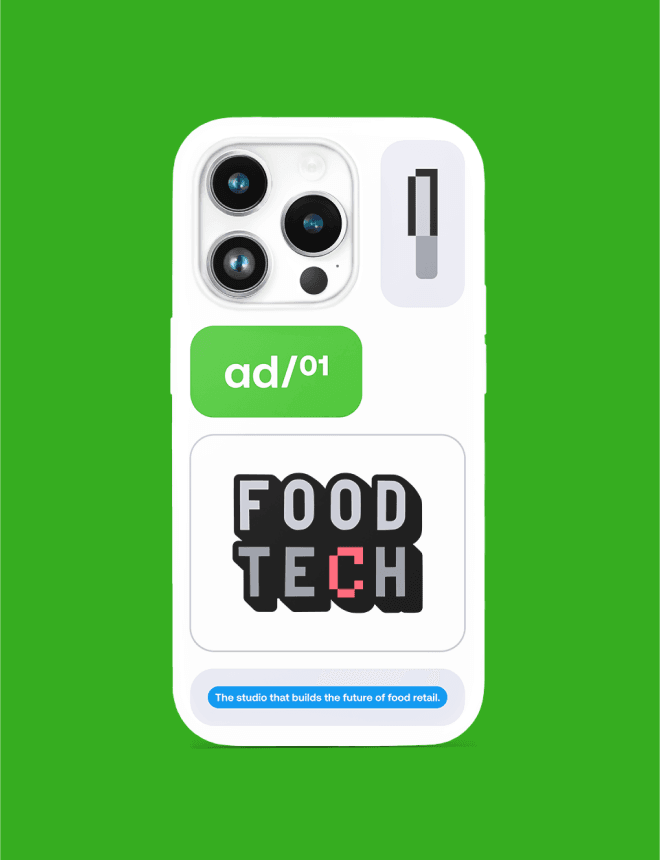 White smartphone case with triple camera lenses on green background, decorated with a green "ad/01" sticker and a bold "FOOD TECH" logo sticker.
