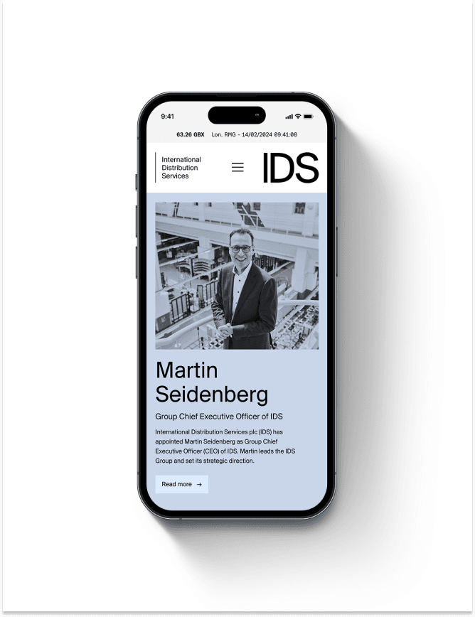 Smartphone displaying IDS website with portrait of a man in a suit, headline announcing new Group CEO and brief article text.