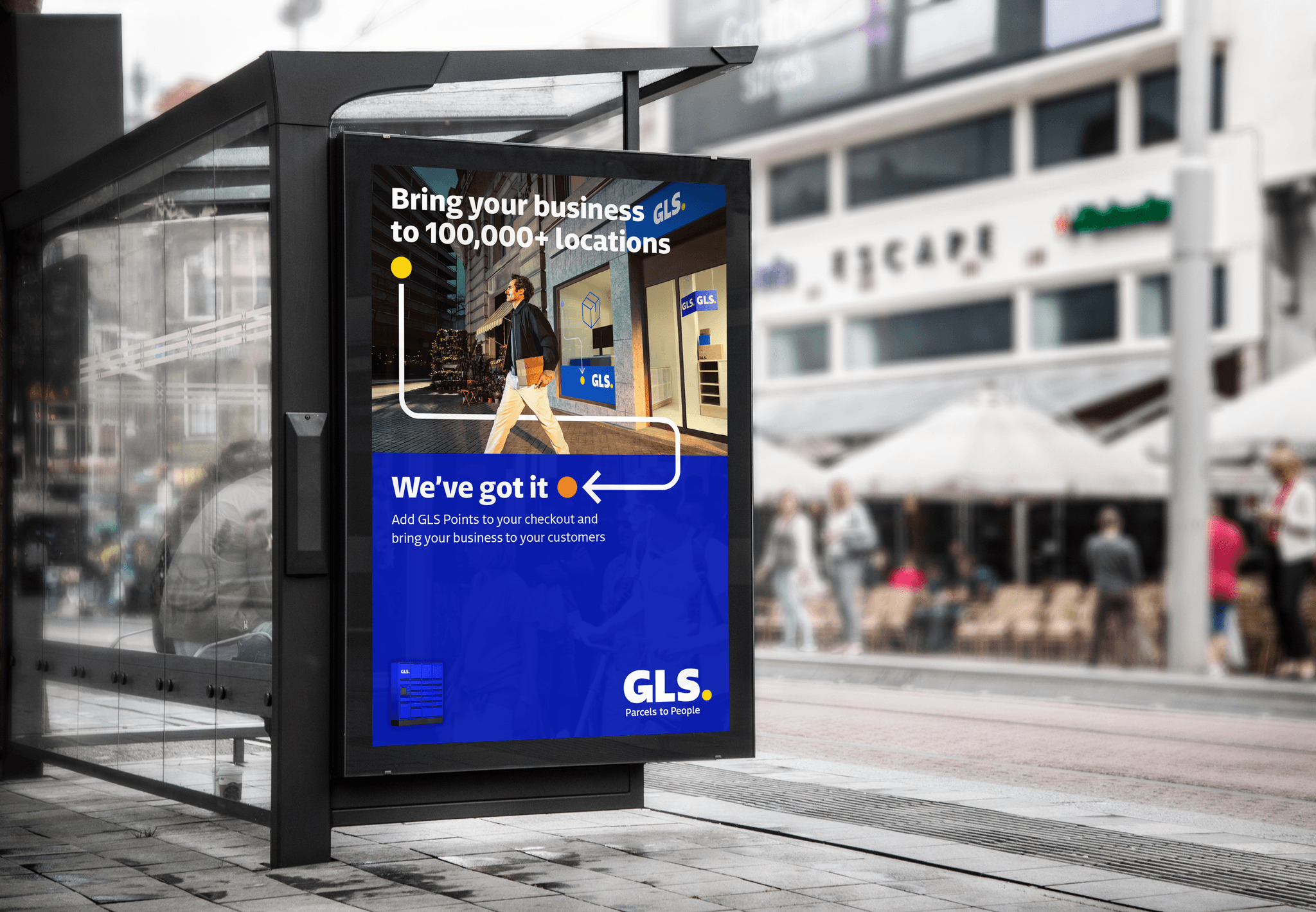 An outdoor digital advertisement at a bus stop shows a man carrying a parcel past a GLS storefront. The ad's text reads, "Bring your business to 100,000+ locations" and "We’ve got it," alongside the GLS logo.