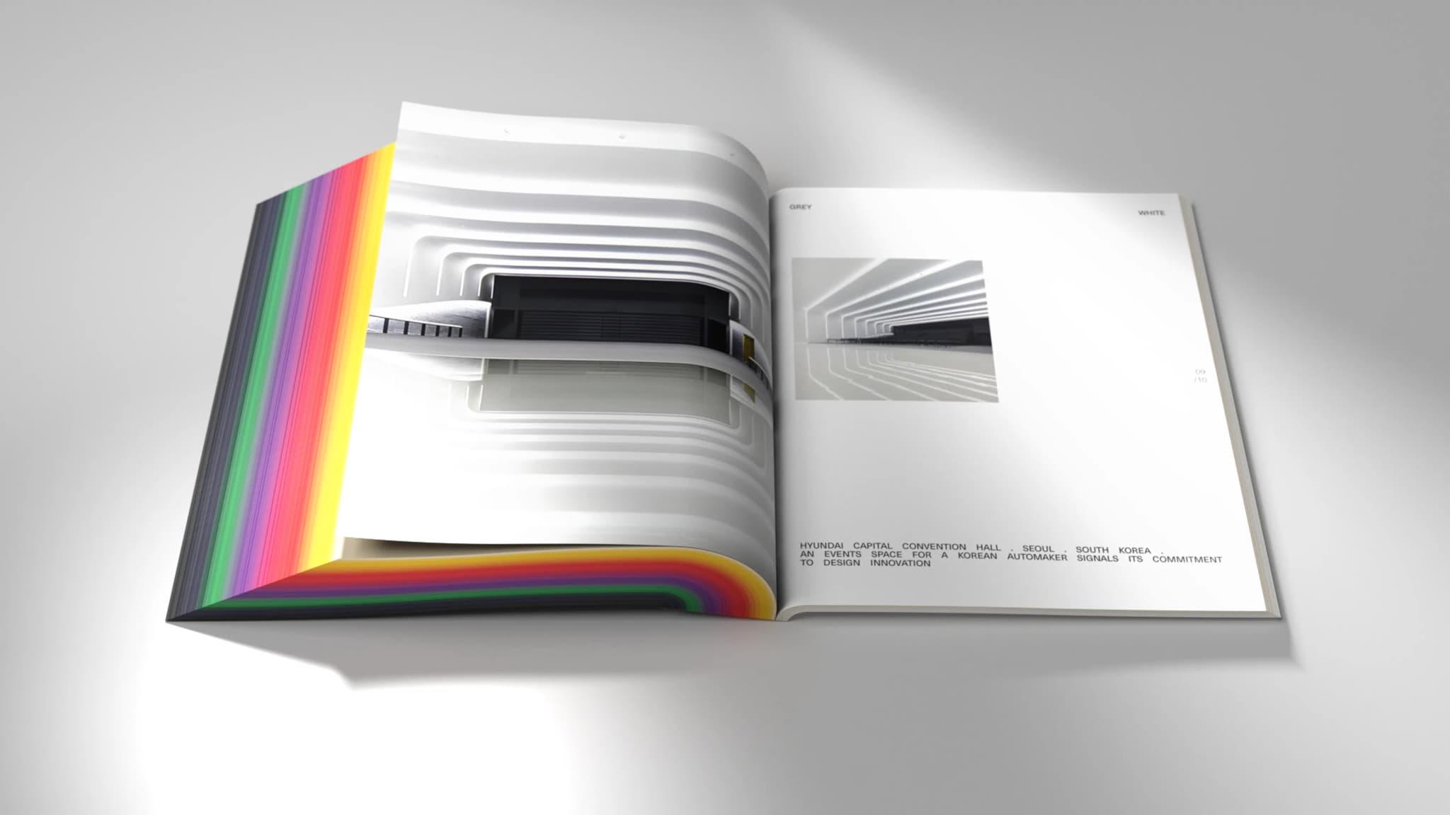 An open book with a colorful edge displays images and text about Hyundai Capital Convention Hall, featuring a modern interior design.