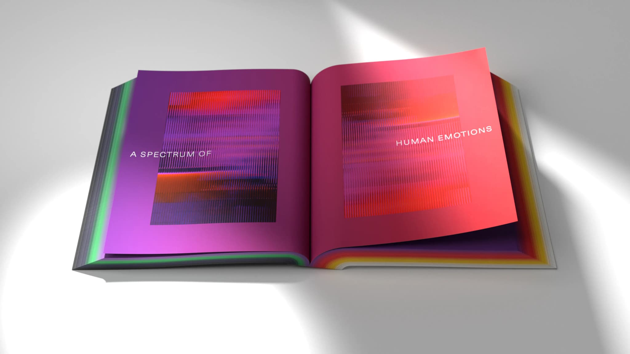 Open book with colorful abstract graphics and text reading "A Spectrum of Human Emotions" across the pages.